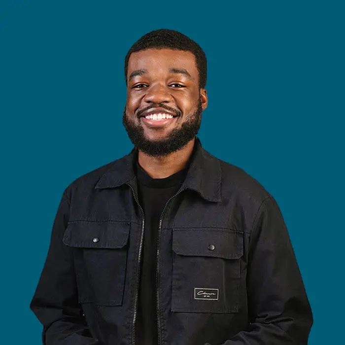 men in front of a dark blue background