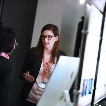 Final year student talking to industry representative at the software Innovation event