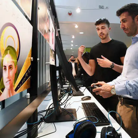 two-men-at-Digital-Design-Show-one-man-holding-a-games-console