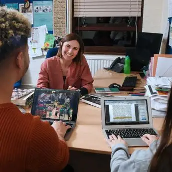 Student and academic sitting in office