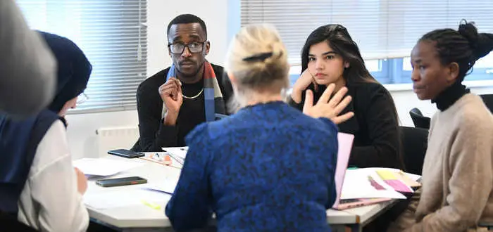group of Brunel law students working around a desk