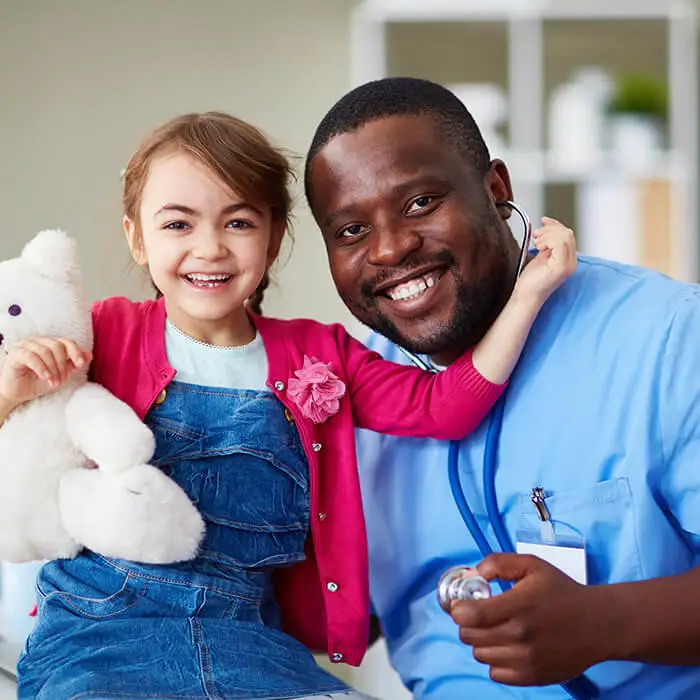 male nurse and small child in examination room