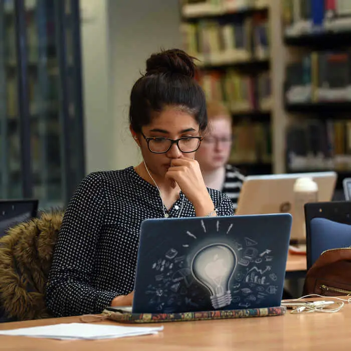 young female behind a laptop