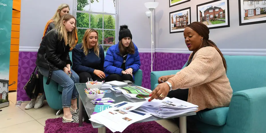 Group of female students looking at accommodation paperwork