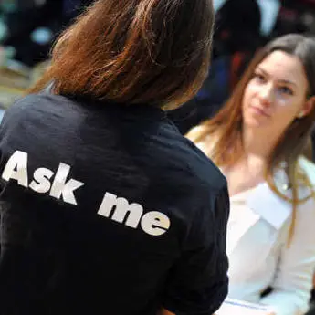 prospective student talking to student ambassador at postgraduate open evening